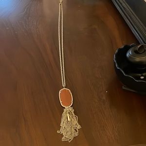 Kendra Scott gold necklace with burnt orange pendant